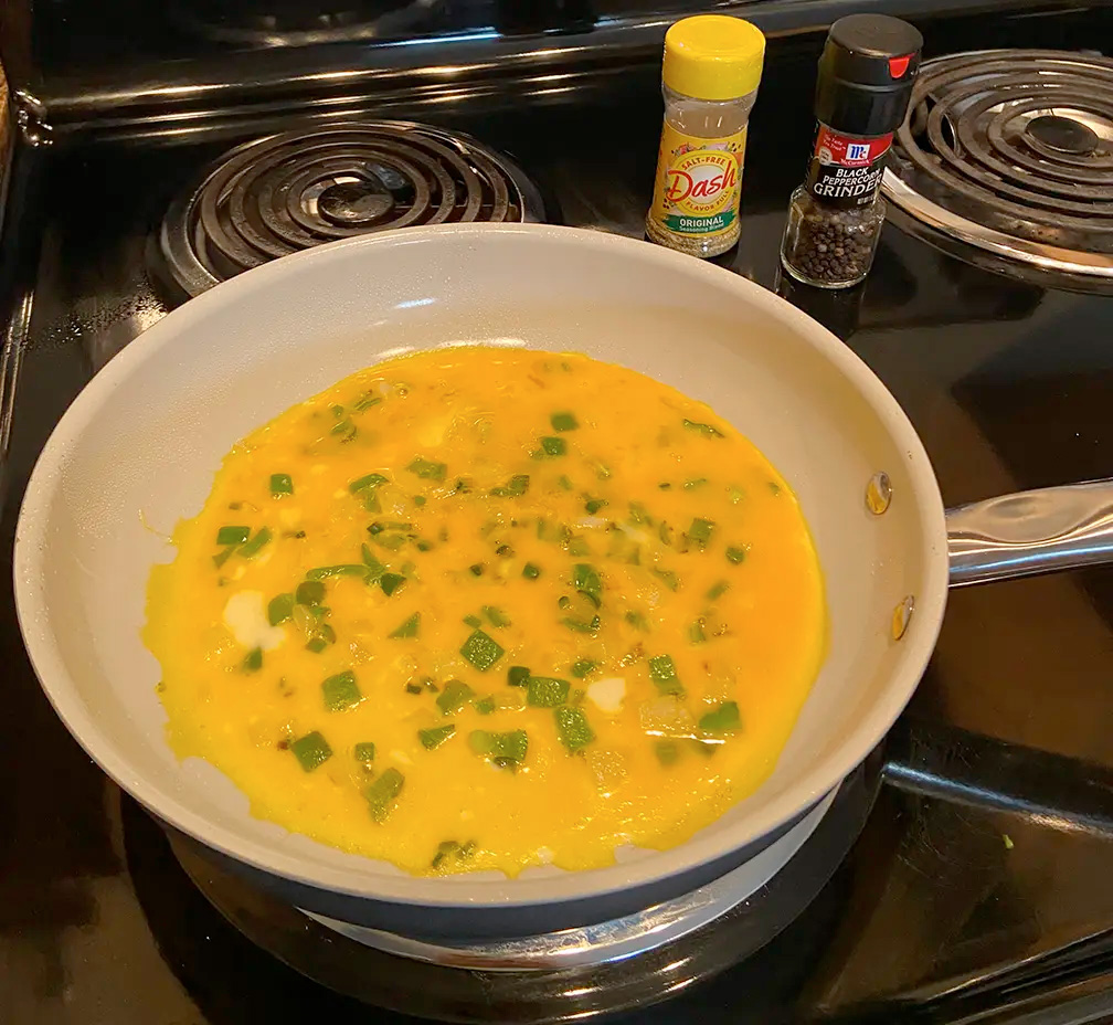 Eggs and Onions Cooking in a pan